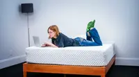A woman lies on the leesa hybrid mattress