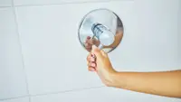 Woman turning on shower
