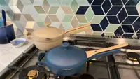 Mini Always Pan and Mini Perfect Pot, covered on top of a gas range.