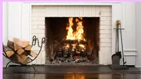 Wood logs burning inside of fireplace.