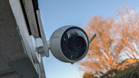 The The Ezviz C3W Pro hangs outside overlooking a yard