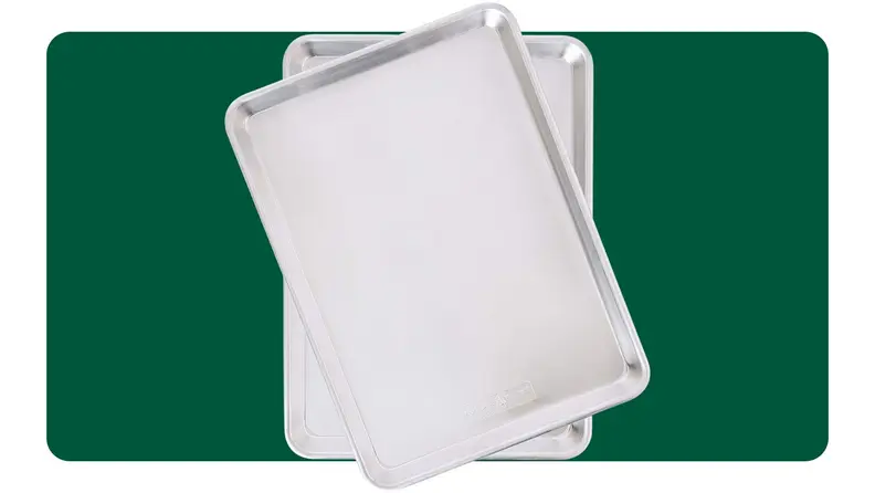 Two baking sheets on a green background