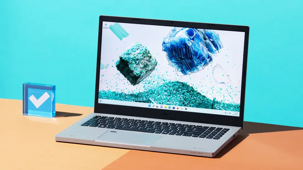 The Acer Aspire Vero (2022) on a desktop with a baby blue background.